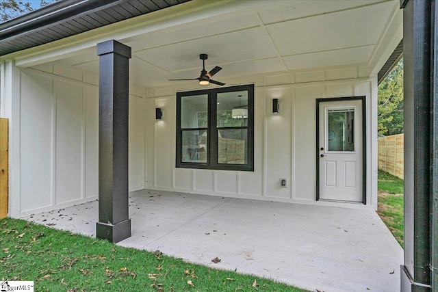 view of exterior entry with a patio area and ceiling fan