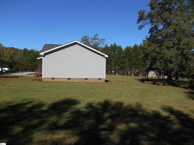 view of side of home with a gazebo and a lawn