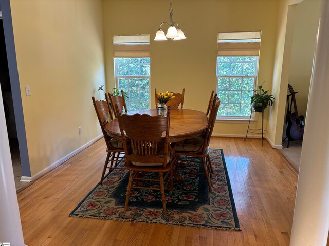 dining area featuring a notable chandelier and light hardwood / wood-style floors