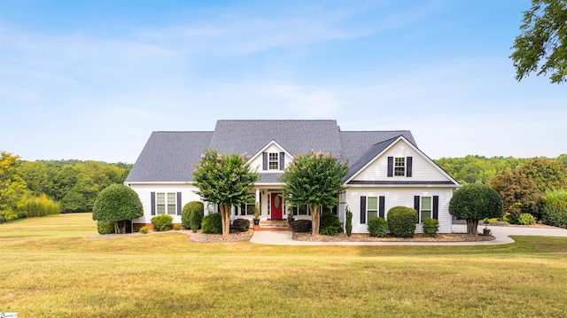 cape cod house featuring covered porch and a front lawn