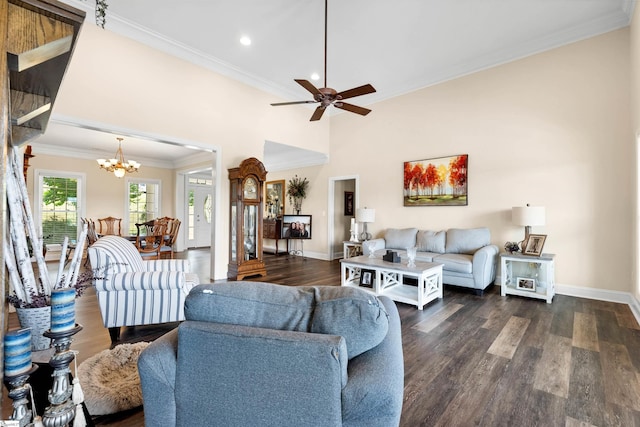 living room with ornamental molding, dark hardwood / wood-style flooring, and ceiling fan with notable chandelier