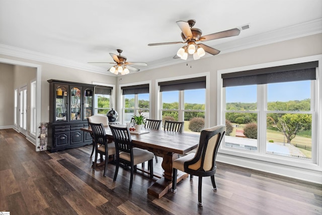 dining space with ornamental molding, dark wood-type flooring, plenty of natural light, and ceiling fan