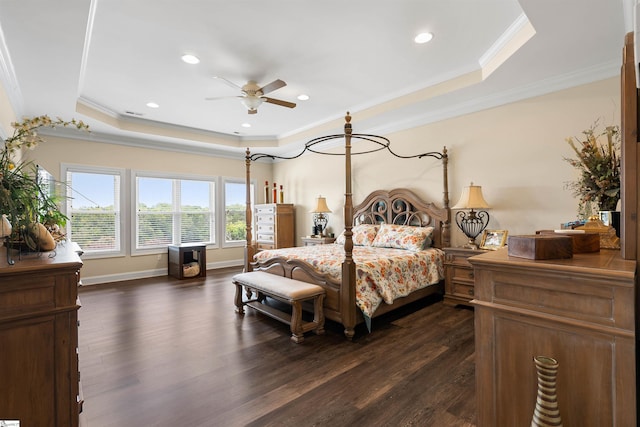 bedroom featuring crown molding, a tray ceiling, and dark hardwood / wood-style floors