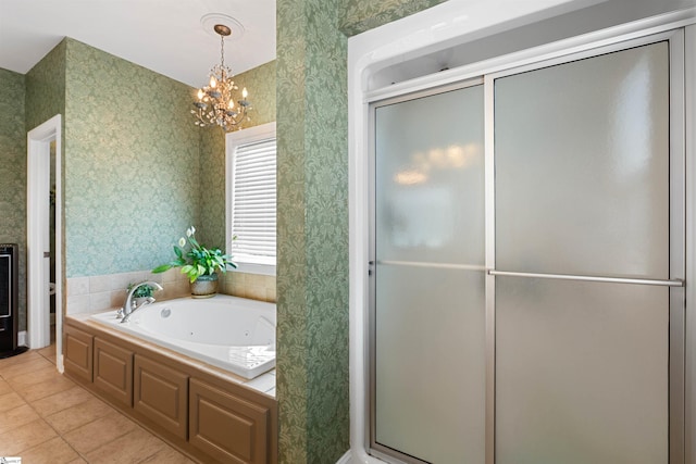 bathroom with tile patterned floors, plus walk in shower, and an inviting chandelier