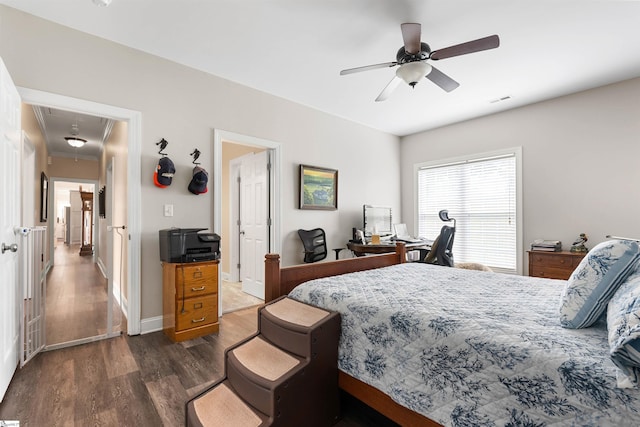 bedroom with ceiling fan and dark hardwood / wood-style floors