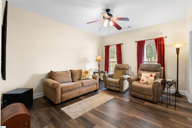 living room with dark wood-type flooring and ceiling fan