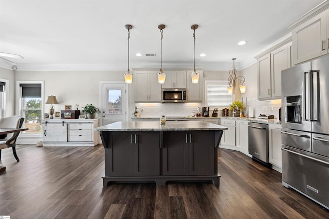 3560 Pelzer Hwy, Easley, SC 29642 - kitchen with stainless steel appliances, a kitchen island, light stone counters, backsplash, and crown molding