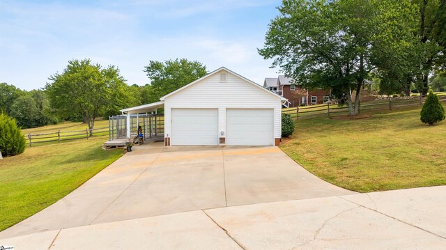 garage featuring a lawn