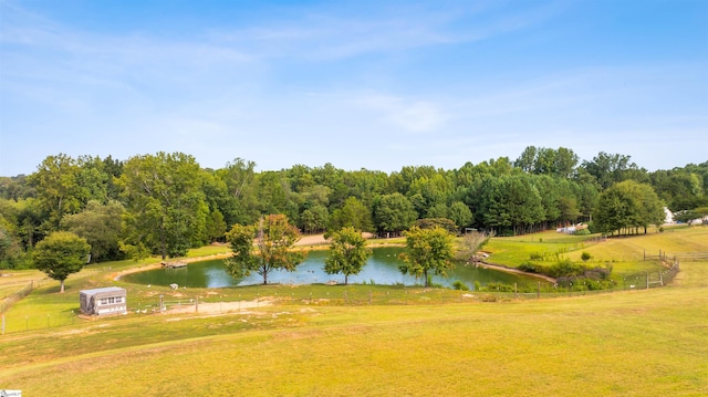 view of home's community featuring a lawn, a water view, and a rural view