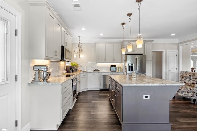 kitchen featuring decorative backsplash, a kitchen island, dark wood-type flooring, pendant lighting, and stainless steel appliances