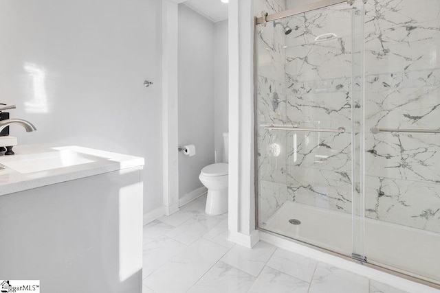 bathroom featuring vanity, toilet, and a shower with door