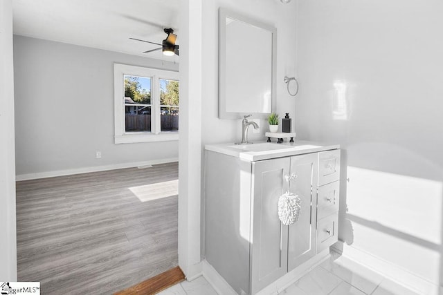 bathroom featuring ceiling fan, vanity, and wood-type flooring