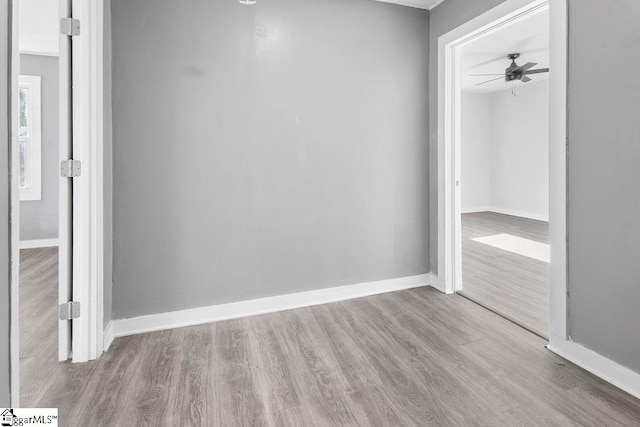 unfurnished room with ceiling fan and light wood-type flooring