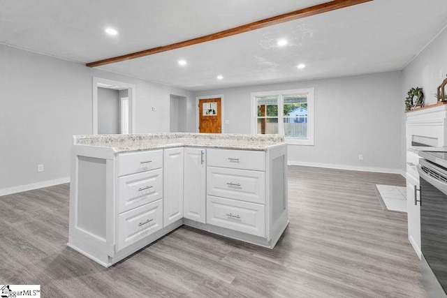 kitchen featuring light stone countertops, light hardwood / wood-style floors, and white cabinets