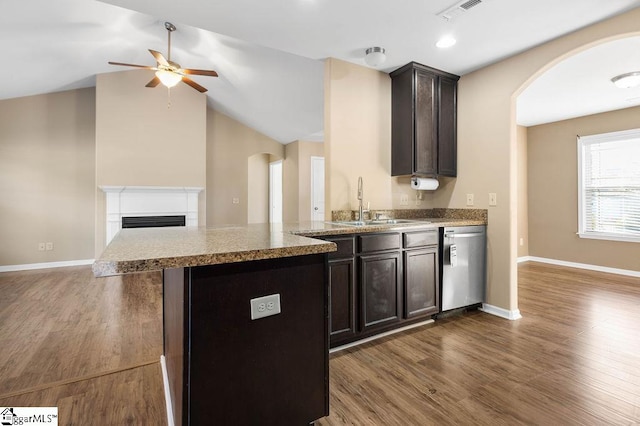 kitchen with ceiling fan, vaulted ceiling, dishwasher, dark hardwood / wood-style floors, and sink