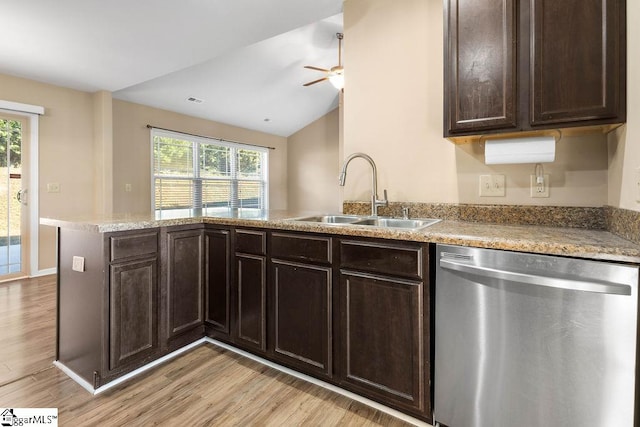 kitchen with kitchen peninsula, stainless steel dishwasher, vaulted ceiling, light hardwood / wood-style flooring, and sink