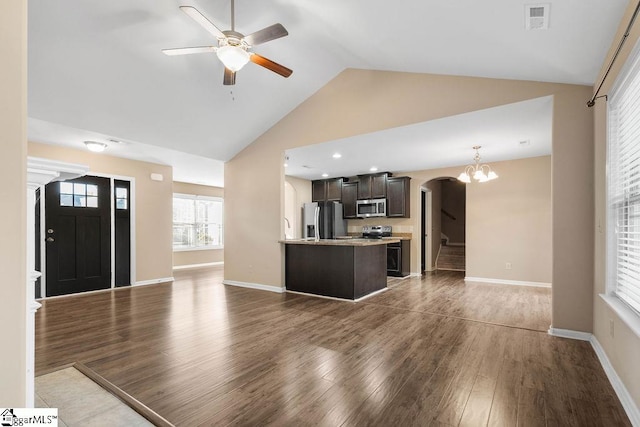 unfurnished living room featuring high vaulted ceiling, ceiling fan with notable chandelier, and dark hardwood / wood-style flooring