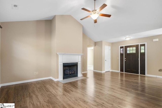 unfurnished living room with hardwood / wood-style floors, high vaulted ceiling, and ceiling fan