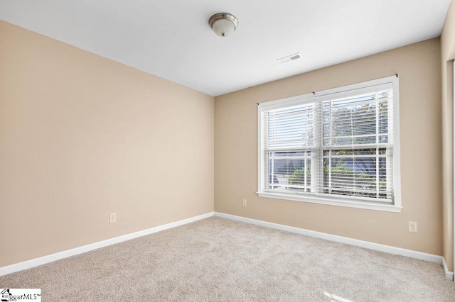 unfurnished room with light colored carpet