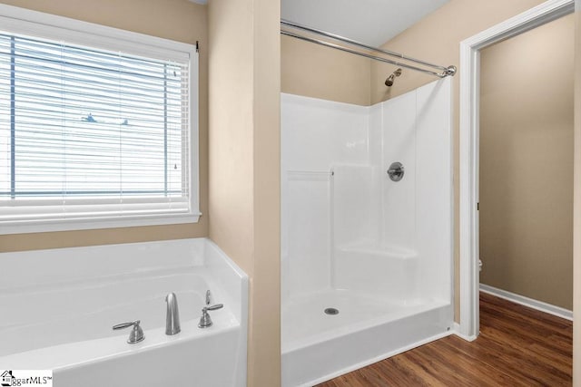 bathroom featuring toilet, hardwood / wood-style flooring, and separate shower and tub