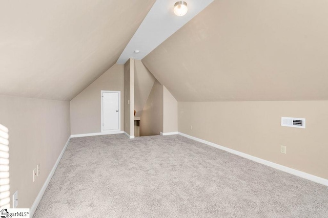 bonus room with carpet and vaulted ceiling