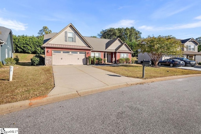 craftsman house featuring a front yard and a garage