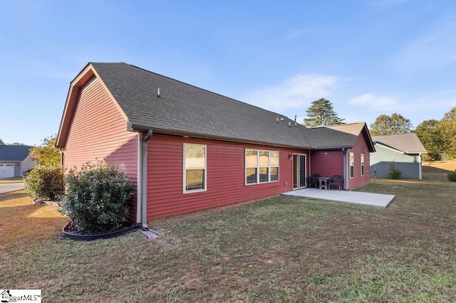 rear view of house featuring a yard and a patio area