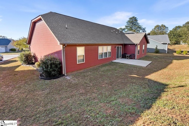 rear view of house with a patio area and a lawn