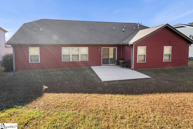 back of house featuring a patio and a lawn