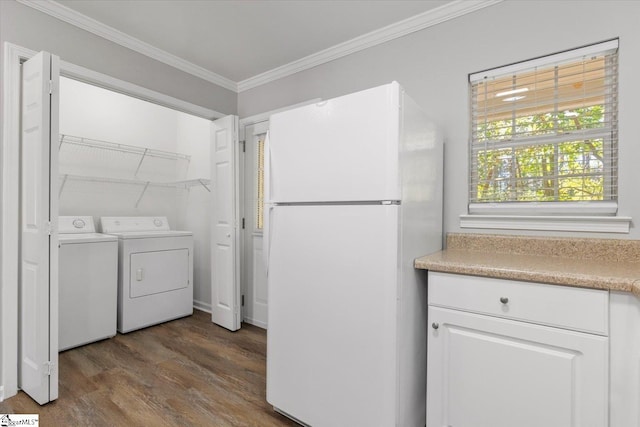 laundry room with crown molding, wood-type flooring, and washer and clothes dryer