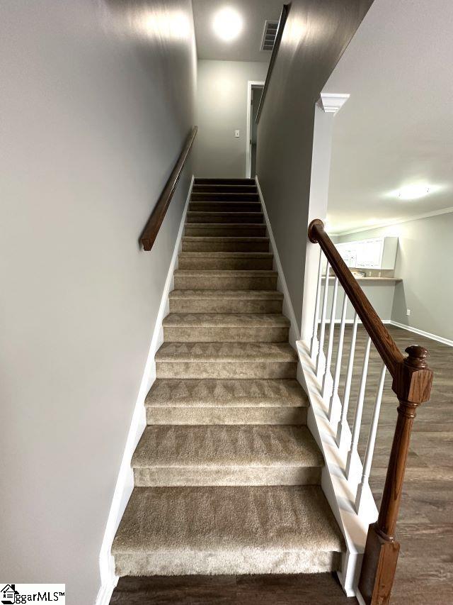 stairway with wood-type flooring