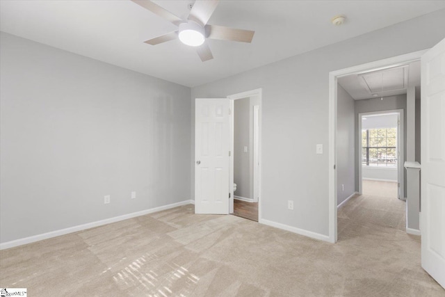 unfurnished bedroom featuring light carpet and ceiling fan