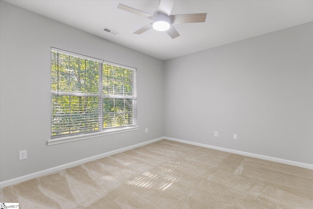 carpeted spare room with ceiling fan