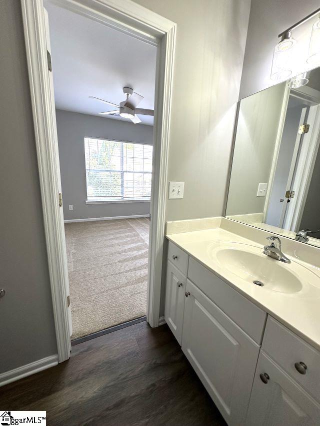 bathroom with vanity, hardwood / wood-style floors, and ceiling fan