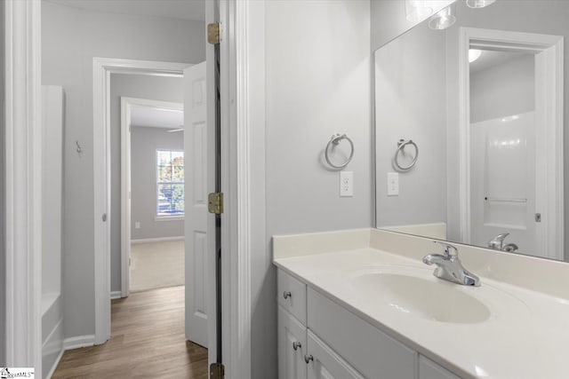 bathroom with vanity, hardwood / wood-style flooring, and independent shower and bath