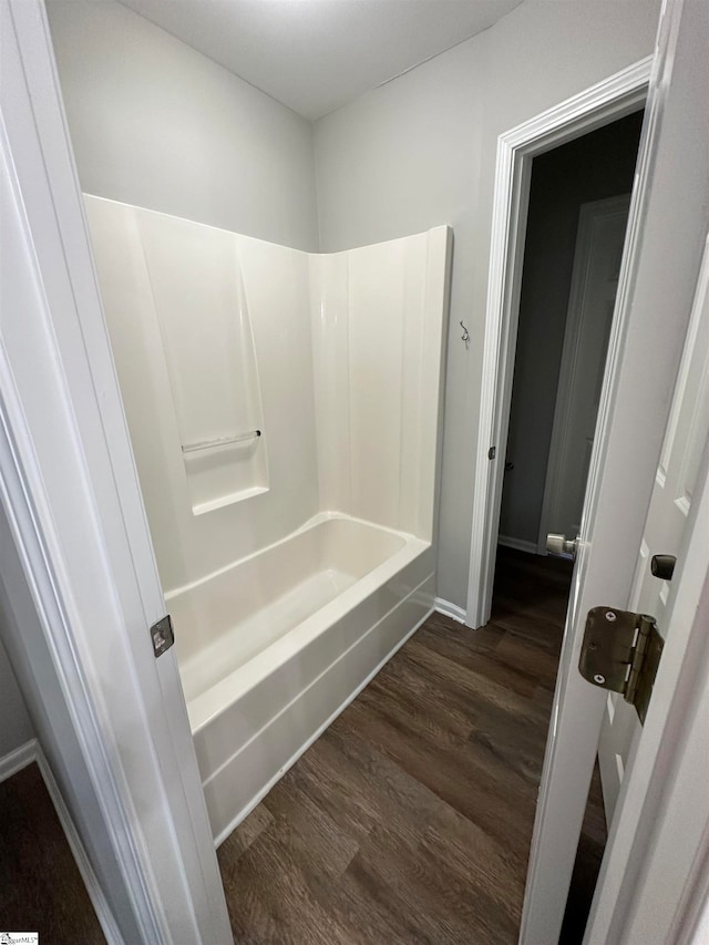 bathroom featuring bathtub / shower combination and wood-type flooring