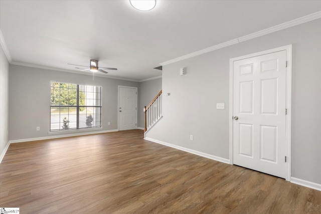 spare room with ornamental molding and wood-type flooring