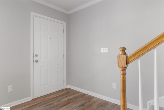 entrance foyer featuring ornamental molding and dark hardwood / wood-style flooring