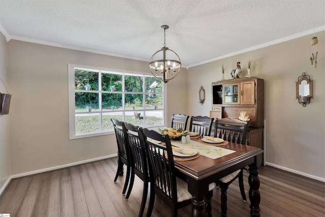 dining room with crown molding, a textured ceiling, a chandelier, and wood-type flooring