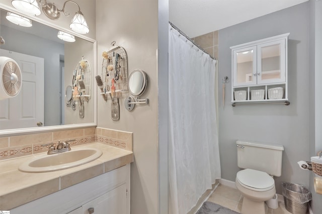 bathroom featuring backsplash, toilet, walk in shower, vanity, and tile patterned flooring