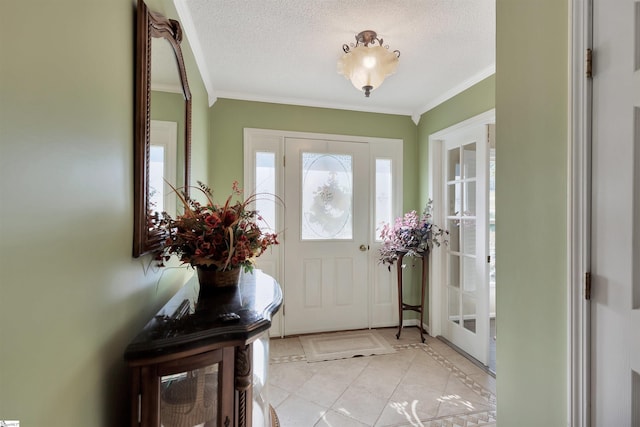 foyer entrance featuring crown molding, a textured ceiling, and light tile patterned flooring