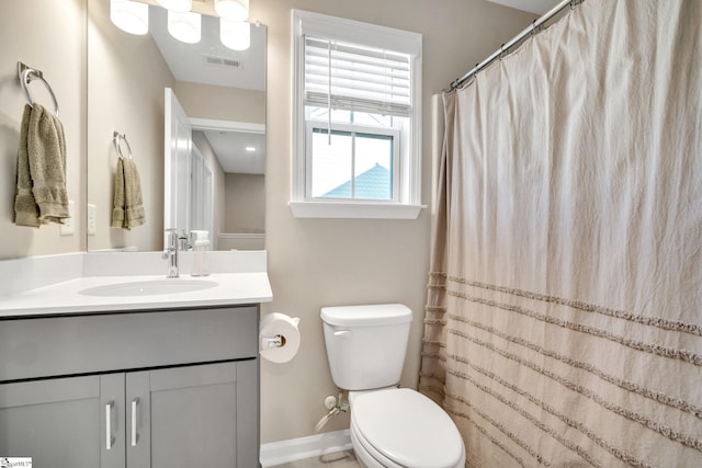 bathroom with toilet, curtained shower, and vanity