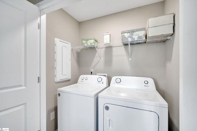 washroom with electric panel and washer and dryer