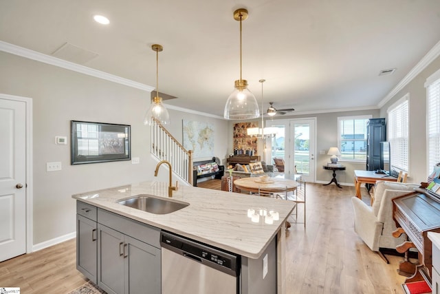 kitchen featuring light stone countertops, sink, dishwasher, ceiling fan, and light hardwood / wood-style flooring