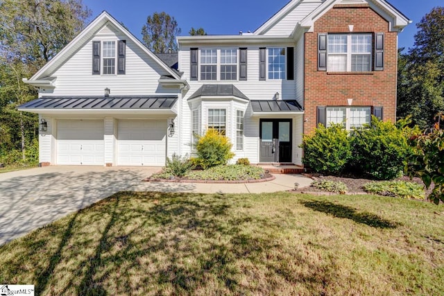 view of front of home with a garage and a front lawn