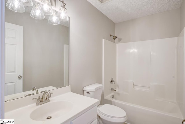 full bathroom featuring  shower combination, vanity, a textured ceiling, and toilet