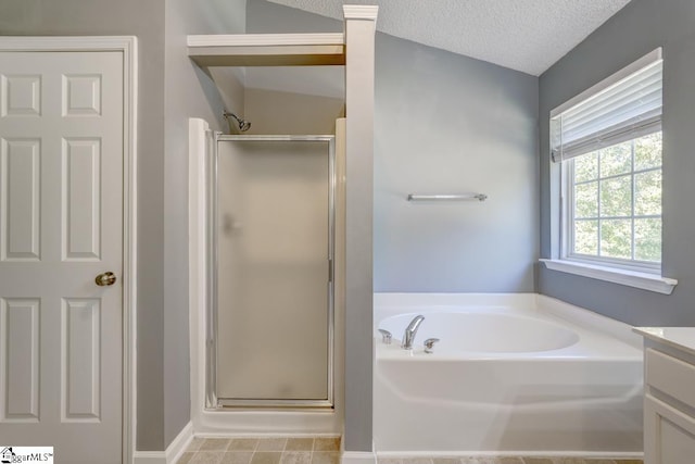 bathroom with vanity, a textured ceiling, vaulted ceiling, and separate shower and tub