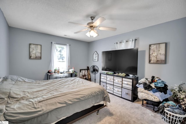 bedroom with carpet, a textured ceiling, and ceiling fan