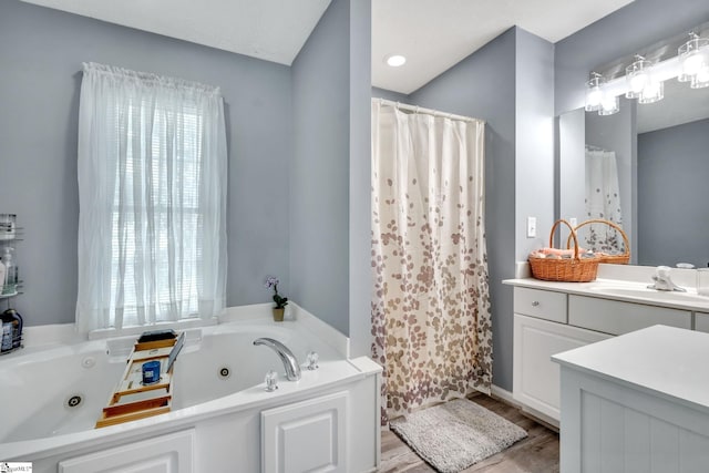 bathroom with vanity, wood-type flooring, and a bathing tub