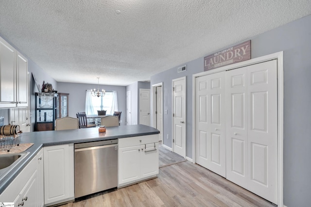 kitchen with dishwasher, pendant lighting, white cabinetry, a textured ceiling, and light hardwood / wood-style floors